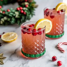 two glasses filled with cranberry lemonade and garnished with candy canes