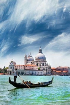 a gondola on the water with buildings in the background