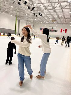 two women are dancing on an ice rink