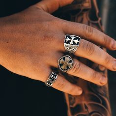 Introducing the Crusader's Ring—a powerful union of silver and brass, embodying valor and virtue. This ring is not merely an ornament; it's a bastion of belief, a symbol of the courage that guides those who wear it. With its layered cross design, it's a modern relic that speaks to the soul's journey through trials and triumphs. The ring features a bold, brass cross, its textured surface catching the light and the eye, nestled into a bed of blackened silver. This contrast is no coincidence; it's Layered Crosses, Souls Journey, Cross Ring, Cross Design, Cross Designs, Crusades, Signet Ring, Brass, Ring