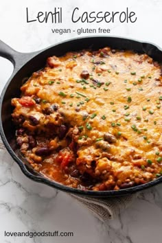 a casserole with meat and vegetables in a skillet on a marble surface