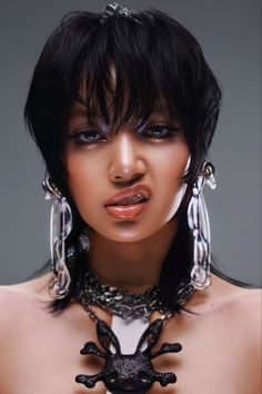 a woman with black hair and silver jewelry