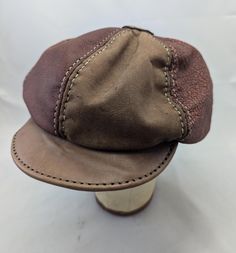 Handmade and hand stitched six panel Leather newsboy hat in maroon and tan.  Hat is sized at 23.6 inches on the inside with a little stretch.  If you have any questions please message before purchase. Classic Brown Six-panel Baseball Cap, Classic Brown Baseball Cap, One Size Fits Most, Brown Leather Curved Brim Baseball Cap, Classic Brown Baseball Cap One Size Fits Most, Adjustable Six-panel Brown Baseball Cap, Brown Adjustable Six-panel Baseball Cap, Classic Brown Flat Cap Baseball Cap, Brown Adjustable Fitted Baseball Cap, Adjustable Brown Fitted Cap