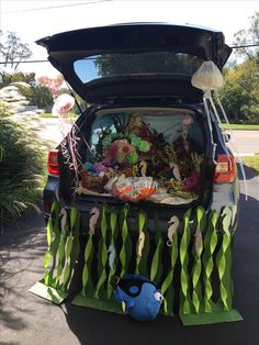 the trunk of a car is filled with toys and other things to be seen in it