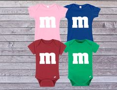 M&M Baby onesies or t-shirts. Perfect for a costume, birthday, or just an everyday outfit. If you are buying 2 or more use code: GOT15 for 15% off. The product is 100% cotton and very comfortable. The fabric is completely opaque and the fabric and design are machine washable. If you have any questions please contact seller. Thank you for stopping by 😊 Cute Short Sleeve Onesie For Gender Reveal, Funny Short Sleeve Onesie For Birthdays, Funny Short Sleeve Onesie For Birthday, Cute Fitted Pre-shrunk Onesie, Fitted Short Sleeve Playful Onesie, Fun Short Sleeve Onesie For Playtime, Funny Short Sleeve Bodysuit For Birthday, Customizable Fitted Playful Onesie, Playful Short Sleeve Onesie For Gender Reveal