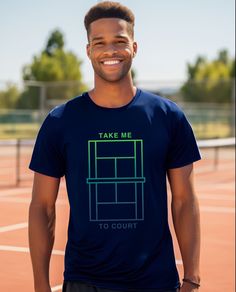 a man standing on a tennis court wearing a t - shirt that says take me to court