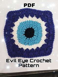 an evil eye crochet pattern is shown in blue, white and black colors