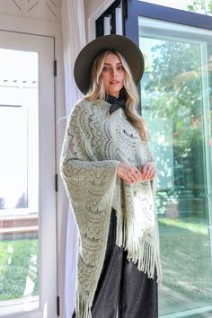 **This product is shipped by a third party warehouse within the US and may arrive separately from your complete order. This is the perfect poncho for a chilly day! The soft, cozy fabric will keep you warm while the cute scallop lace detail adds a touch of style. You'll love wearing this poncho with jeans and boots or dress it up with a skirt and heels. #lovemyleto Imported One Size Knit Poncho With Fringe, Cozy Poncho For Cold Weather, Winter Knit Sweater With Lace Trim, Cozy Winter Cape Shawl, Cozy Winter Poncho With Fringe, Cozy Knitted Fall Shawl, One Size Crochet Shawl For Fall, Long Sleeve Fringe Poncho, Crochet Shawl For Fall