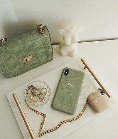 a purse, cell phone and other items on a table