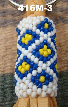 a keychain made out of balloons and beads with the number 4 on it