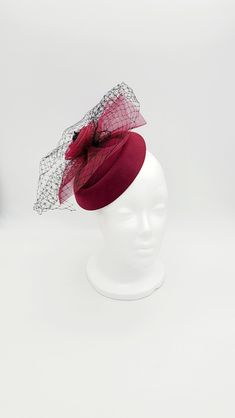 Beatrice - an elegant burgundy/wine colored fascinator with black and burgundy accents. There is a clip on the inside of the fascinator for securing in place. This stunning handmade hat would be perfect for horse races, the Kentucky Derby, Melbourne Cup, Easter, weddings (Bridal Hat or Mother-of-the-Bride/Groom), church, christening, tea parties, cocktail parties, birthdays, bridal showers, engagement parties, bachelorette parties, baby showers, Mother's Day or just because you're ready to slay. Luxury Red Fitted Fascinator, Winter Evening Fascinator, Fitted Winter Evening Fascinator, Elegant Fitted Mini Hats For Holiday, Elegant Burgundy Hat For Winter, Elegant Mini Hats For Wedding And Holiday, Winter Party Fascinator, Elegant Fitted Headpieces For Holiday, Elegant Winter Party Fascinator