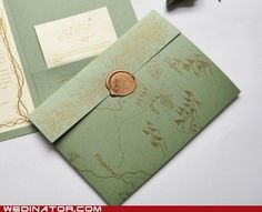 two green envelopes with a wax stamp on them, one has a gold seal