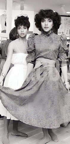 two women in dresses standing next to each other