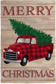 a red truck with a christmas tree on the back is sitting in front of a wooden sign