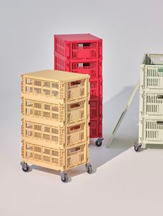 three different colored crates sitting next to each other