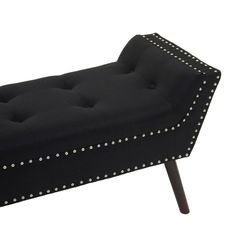 an upholstered bench with studded trimmings on the legs and back