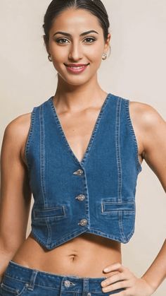 Fulfill your denim dreams with our must-have Medium Wash Denim Vest Top, the ultimate addition to your wardrobe. This vest is made from a blend of comfortable and stylish materials, including 72% cotton, 24% polyester, 3% rayon, and 1% spandex. With 3 buttons in the front, you can easily add a touch of denim to any outfit. Don't miss out on looking like a denim queen - make this essential piece yours today! Model is 5'3" tall, wearing size Large * Color may vary slightly due to monitor resolutio Trendy Denim Workwear Vest, Trendy Denim Work Vest, Trendy Cotton Vest With Snap Buttons, Trendy Medium Wash Vest With Buttons, Trendy Cotton Denim Vest With Snap Buttons, Trendy Dark Wash Denim Vest For Work, Trendy Denim Vest With Button Closure, Sleeveless Denim Jacket For Summer Workwear, Medium Wash Buttoned Vest For Fall