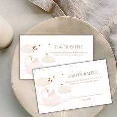 two place cards sitting on top of a plate next to a cup and saucer