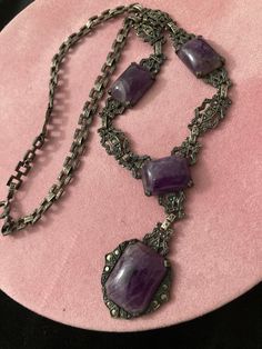 "COUPON CODE available at check out.  Antique 19th C Medieval Revival sterling amethyst stone pendant necklace. 13 marcasites dot this necklace. There are patterns within patters. Faux marcasite studs thru out. Picture frame style  filigree cut out sturdy flat solid sterling panels for bottom half of necklace.  An intricate flat square interlocking chain for the upper half. The square chain links are all intricately designed.  Back of center pendant is marked sterling.  Largest stone MEASURES:  Approx 3/4\" x 1/2\" (little more). Next 3 measure the same at approx: 1/2\" x 1/2\" (a little more.) Purple stone is freezing cold to the touch. Regular flashlight shown under light. See all photos. No cracks in any stones. Email any questions prior to purchase.  My opinion of the style might be di Antique Sterling Silver Necklace, Ornate Amethyst Necklaces For Formal Occasions, Handmade Vintage Amethyst Jewelry, Victorian Antique Silver Pendant Necklace, Victorian Jewelry With Oxidized Finish, Collectible, Ornate Silver Amethyst Necklace, Hallmarked Amethyst Pendant Necklace, Antique Handmade Purple Jewelry, Ornate Purple Gemstone Necklaces