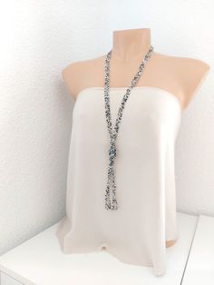 "This is a beaded long necklace that measures about 44 inches long in total in a sparkly silver color. The knot is adjustable, simple to undo and redo at the height you would like! Or you can wear the necklace double up without any knot! It is a very versatile necklace that can be adapted to your taste.   ❤ PROCESSING AND SHIPPING Most orders are made and shipped out in one business day. Please check delivery timeframes for your location on the description below.  ❤ CUSTOM ORDERS If you like this item in a different color, send me a message indicating: color, size and quantity needed. I will send you a link for a \"custom order\" and you'll be able to place the order there.  If you like this item with some variations such as thickness or style, please also send me a message and I will work Beaded Silver Layered Necklace For Party, Silver Multi-strand Beaded Necklace For Party, Silver Lariat Necklace For Party, Bohemian Silver Long Necklace With Round Beads, Silver Bohemian Long Necklace With Round Beads, Silver Beaded Backdrop Necklace For Party, Long Silver Bead Necklace For Party, Long Silver Beaded Necklace For Parties, Long Silver Beads Necklace For Parties