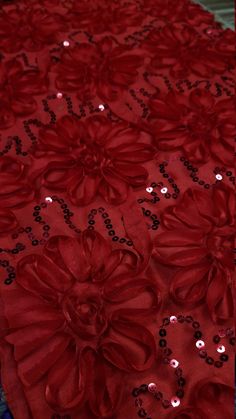 red table cloth with flowers and sequins on it