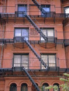 an apartment building with many windows and stairs