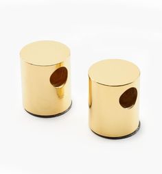 two gold colored metal containers on a white background