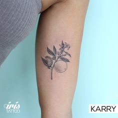 a woman's arm with a tattoo on it that has a peach and leaves