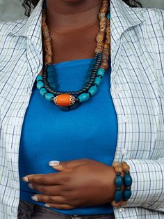 Handcrafted and inspired by local artisans in the Krobo mountains of Ghana, the Agudie Necklace is a statement piece perfect for any occasion. Made from unique powdered glass beads, fired in kilns for durability, and featuring both Krobo and Ashanti beads, this necklace makes for a stunning addition to your jewelry collection. Artisan Blue Wooden Beads, Unique Recycled Glass Large Bead Necklaces, Blue Jewelry With Wooden Beads, Unique Necklaces With Large Recycled Glass Beads, Unique Blue Wooden Beads, Artisan Jewelry With Large Recycled Glass Beads, Blue Wooden Beads, Artisan Beaded Necklaces With Recycled Glass, Blue Beaded Necklace In Recycled Glass