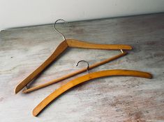 two wooden clothes hangers sitting on top of a table