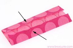 the sewing needle has been sewn on with pink polka dots and is next to an empty piece of fabric