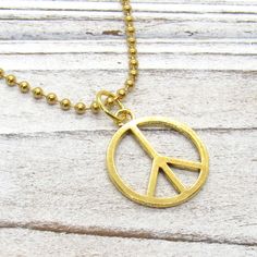 Gold Peace Sign Necklace, Peace Symbol Pendant, Peace Pendant Necklace, Hippie Necklace, Boho Necklace, Necklace for Men, Men's Necklace, Woman's Necklace, Peace Sign Jewelry, Peace Sign, Peace NECKLACE STYLE AND LENGTH: Please select the style and length of necklace from the drop down lists. Yellow Gold Tone Stainless Steel Chains: Flat Link 4 x 3 x .8mm, Twist Curb 4 x 3 .8mm and Ball Chain 2.4mm and includes a lobster clasp closure or ball connector for Ball Chain. Waxen Cotton Cord: Strong a Gold Peace Sign Jewelry Gift, Gold Jewelry With Peace Sign For Gift, Peace Sign Jewelry, Peace Jewelry, Peace Necklace, Peace Sign Necklace, Sign Necklace, Brown Jewelry, Hippie Necklace