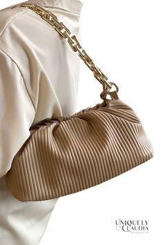 Gorgeous and unique to take your style up a notch...check out our Shaune Pleated Handbag – it's chic, sophisticated, and totally on trend. This ultra-soft vegan leather bag comes with two straps, and it is a 3-in-1...it can me worn as a clutch, under-shoulder, or crossbody. A goldtone bold chainlink, and a crossbody strap that lets you go hands-free. Plus, the pleated design is both eye-catching and elegant, and the handbag itself is spacious enough to hold all your essentials. Whether you're he Soft Faux Leather Clutch Shoulder Bag, Chic Leather Baguette Bag With Chain Strap, Chic Pouch Shoulder Bag With Adjustable Strap, Versatile Faux Leather Shoulder Bag With Gold-tone Hardware, Trendy Faux Leather Baguette Shoulder Bag, Trendy Faux Leather Shoulder Baguette Bag, Trendy Faux Leather Baguette Bag With Adjustable Strap, Trendy Faux Leather Baguette Bag With Double Handle, Versatile Faux Leather Bag With Gold-tone Hardware