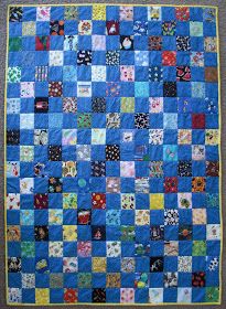 a blue quilt with lots of different colored squares on it