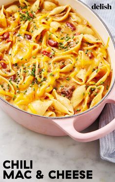 a pink casserole dish filled with macaroni and cheese