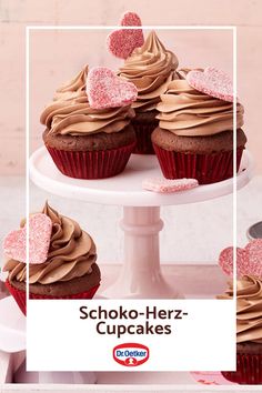 cupcakes with chocolate frosting and pink sprinkles on a cake stand