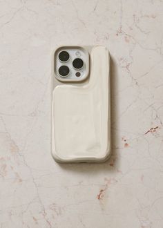 an iphone case sitting on top of a marble surface