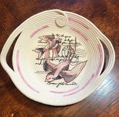 a woven basket with two birds on it