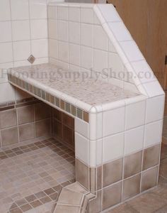 a white bench sitting in the middle of a tiled floor