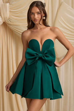 Made for your wow moment, the Norina mini dress is crafted from lustrous and lightweight non-stretch satin to a classic strapless silhouette with a fitted corset bodice for enhanced support and a voluminous organza skirt. In keeping with the festive theme, it’s embellished with a stunning oversized bow that can be detached for multiple styling options.

Plunge sweetheart neck

Strapless

Built-in corset for enhanced shaping

Detachable oversized bow with concealed popper fastenings

Voluminous layered skirt

Concealed side zip fastening

Bodycon silhouette with voluminous skirt

Mini length, SNP to hem approx. 80cm based on a US size 4

This item is part of a two-piece set, both items must be returned for a full refund