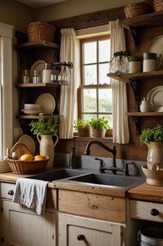 a kitchen sink sitting under a window next to a wooden shelf filled with pots and pans