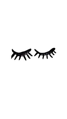 two eyelashes with black glitter on them against a white background