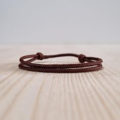 Simple brown string bracelet, made from a nylon cord.  The bracelet has an adjustable size thanks to the sliding knot. This a simple fabric jewelry that can be worn alone or stacked with other bracelets. Suitable for both men and women. The bracelet is fully water-resistant, so you can swim and shower with it. - - - - - - - - - - Materials: Nylon cord  - Cord diameter: 2mm - Color: Brown - - - - - - - - - Sizes: S - Fully Closed - 5.9"inches (15cm) / Full Opened - 11.8"inches (30cm) M - Fully Cl Casual Braided Bracelets With Adjustable Length, Minimalist Braided Bracelets With Adjustable Waxed Cord, Gift Braided Bracelet With Adjustable Length In Nylon Cord, Minimalist Braided Bracelets With Adjustable Cord, Adjustable Sliding Knot Nylon Thread Bracelets, Gift-worthy Braided Bracelet With Adjustable Length, Adjustable Nylon Thread Friendship Bracelets, Adjustable Nylon Thread Friendship Bracelets As A Gift, Everyday Bracelets With Sliding Knot And Nylon Cord