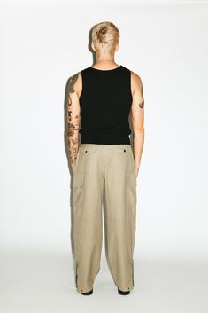 A utility cargo for the ultimate off-duty uniform. Easy-going and relaxed, these cargos are pleated for a slightly wider, straight-leg silhouette. Open the side-zip hems for a sportier 90's aesthetic. Dress down formal blazers and button-ups with an effortless, casual contrast. Casual Cargo Pants With Straight Hem, Utility Style Cargo Pants With Straight Hem, Sporty Relaxed Fit Cargo Pants For Work, Sporty Cargo Parachute Pants For Workwear, Modern Spring Cargo Pants With Cargo Pockets, Modern Spring Cargo Pants With Pockets, Sporty Workwear Parachute Pants With Cargo Pockets, Sporty Tapered Leg Cargo Pants For Work, Streetwear Cargo Pants With Patch Pockets