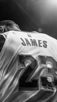 a black and white photo of a man wearing a jersey with the number 24 on it