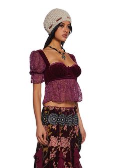 Start the story with this top that has a sheer lace construction, a velvet bustier with an underwire bust, a decorative bow, puffy sleeves with bows, a lettuce trim, and a back zipper closure. Party Lace Tops With Boned Bodice, Fitted Lace Top With Puff Sleeves, Party Tops With Lace Trim And Underbust Shape, Ruffled Fitted Bodice Tops For Party, Ruffled Tops With Fitted Bodice For Parties, Velvet Party Corset, Bustier Top Outfits, Whimsigoth Outfits, Maximalist Outfits