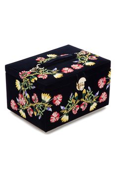 a black box with flowers and leaves on it