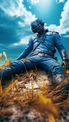 a man sitting on top of a rock in the grass