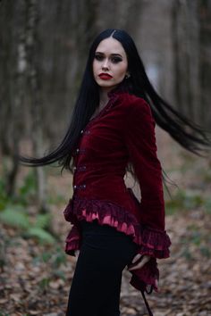 Add a little victorian touch to any ensemble in this gothic-inspired tail jacket!  This elegant steampunk jacket is made out of lush burgundy red velvet and features beautiful lacing in the back, stud decoration, ruffles on the seams and a decorative button closure in the front.  Put it on and look wickedly awesome! Available in sizes  XS, S, M, L, XL, XXL, 3XL and 4XL. Add some victorian chic to your outfit with this stunning velvet steampunk jacket! Vampire Style Fitted Costume Outerwear, Victorian Style Long Sleeve Outerwear For Costume Party, Gothic Red Outerwear For Halloween, Victorian Outerwear For Fall Costume Party, Victorian Outerwear For Costume Party In Fall, Gothic Fitted Outerwear For Costume, Fitted Gothic Costume Outerwear, Red Gothic Outerwear For Winter, Red Gothic Winter Outerwear