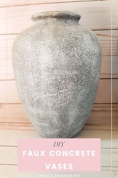 a large gray vase sitting on top of a wooden table next to a pink sign that says diy faux concrete vases